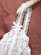 White Sheer Lace Camisole and Thong Lingerie Set with Delicate Straps, Floral Lace Detailing and Split-Hem Silhouette