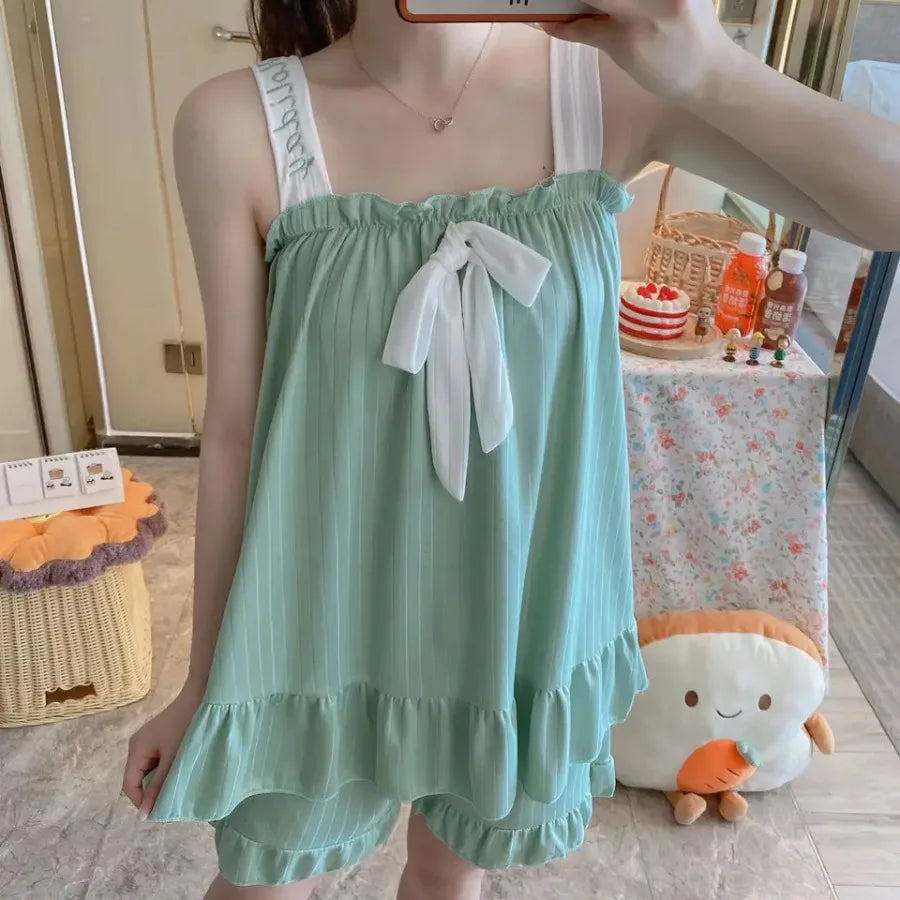 Soft Pink Two-Piece Women's Pajama Set with Bow-Tie Front, Sleeveless Cami Top and Coordinating Ruffle-Hem Shorts