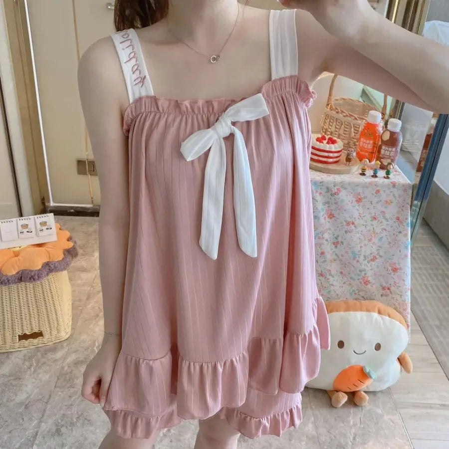Soft Pink Two-Piece Women's Pajama Set with Bow-Tie Front, Sleeveless Cami Top and Coordinating Ruffle-Hem Shorts