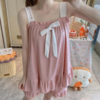 Soft Pink Two-Piece Women's Pajama Set with Bow-Tie Front, Sleeveless Cami Top and Coordinating Ruffle-Hem Shorts