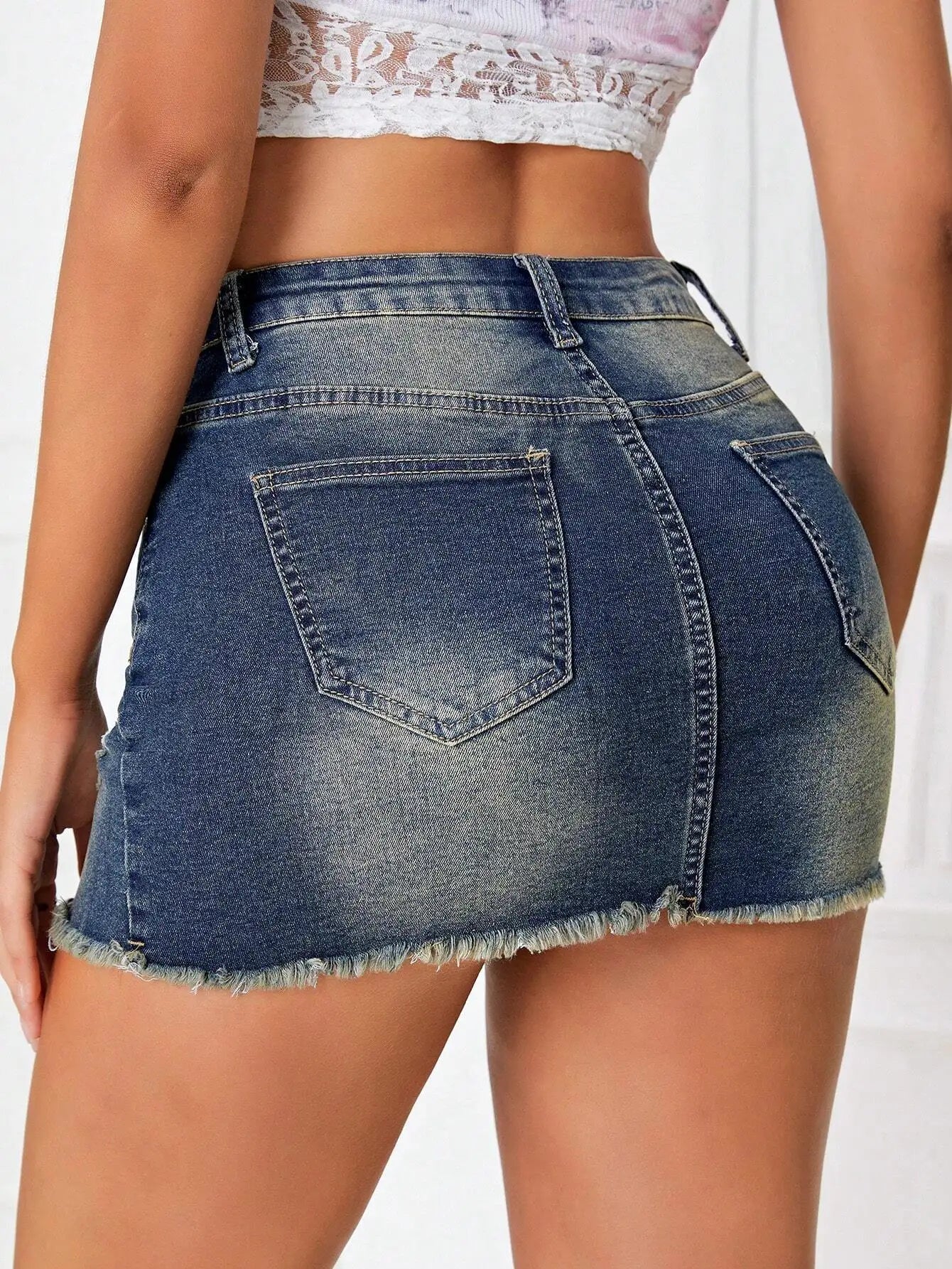 Low Rise Distressed Denim Mini Skirt with Frayed Hem Pocket Detail