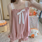 Soft Pink Two-Piece Women's Pajama Set with Bow-Tie Front, Sleeveless Cami Top and Coordinating Ruffle-Hem Shorts