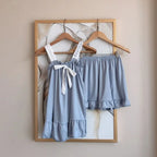 Soft Pink Two-Piece Women's Pajama Set with Bow-Tie Front, Sleeveless Cami Top and Coordinating Ruffle-Hem Shorts