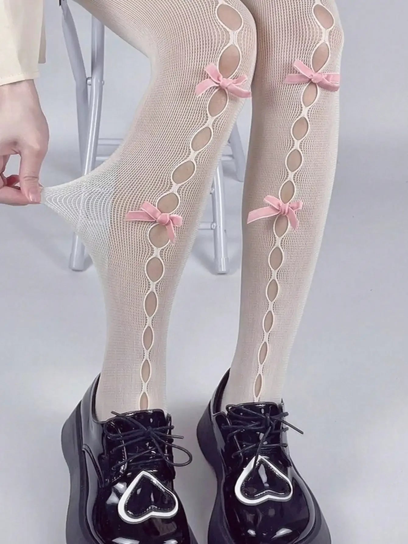 Decorative Bow Fishnet Thigh High Stockings with Open Mesh Pattern for Alternative Fashion Styling