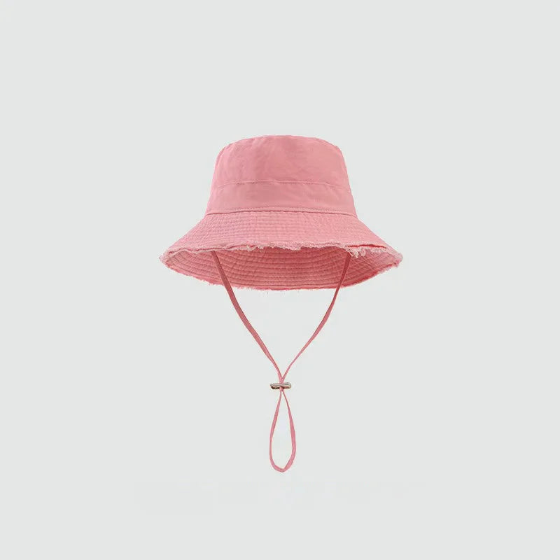 Minimalist Bucket Hat with Soft Brim and Decorative Tassel Detail for Everyday Outdoor Style